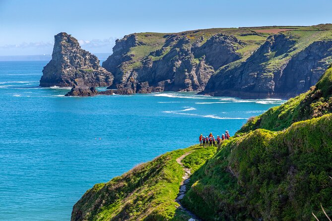 Coasteering Adventures in Bossiney Cove, Bude, and Cornwall - Scrambling across barnacle-covered ledges