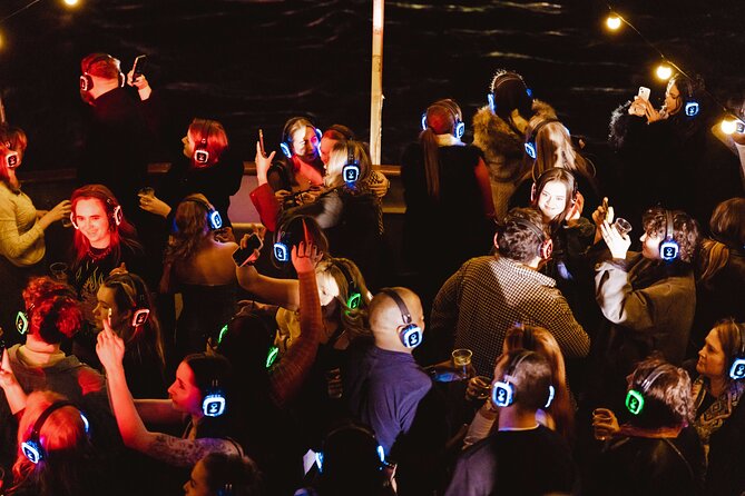 Silent Disco London Thames Boat Party - Canary Wharf glowing after dark